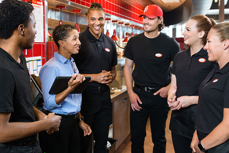 Team Members huddling and prepping for shift